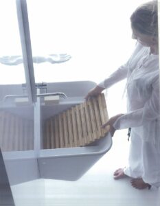 a woman washing a cloth in a basin
